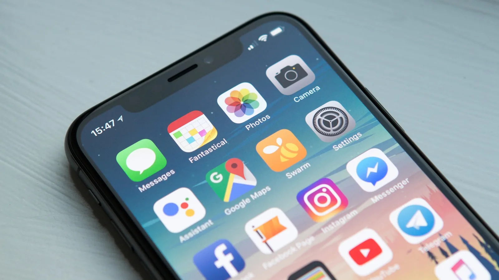 Futuristic smartphone floating in space with holographic progressive web app interface expanding outward and responsive design grids